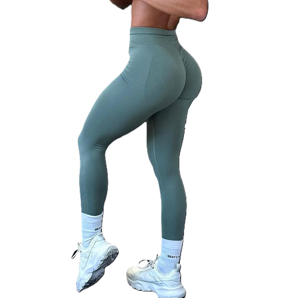 Teal leggings worn by a person on a white background