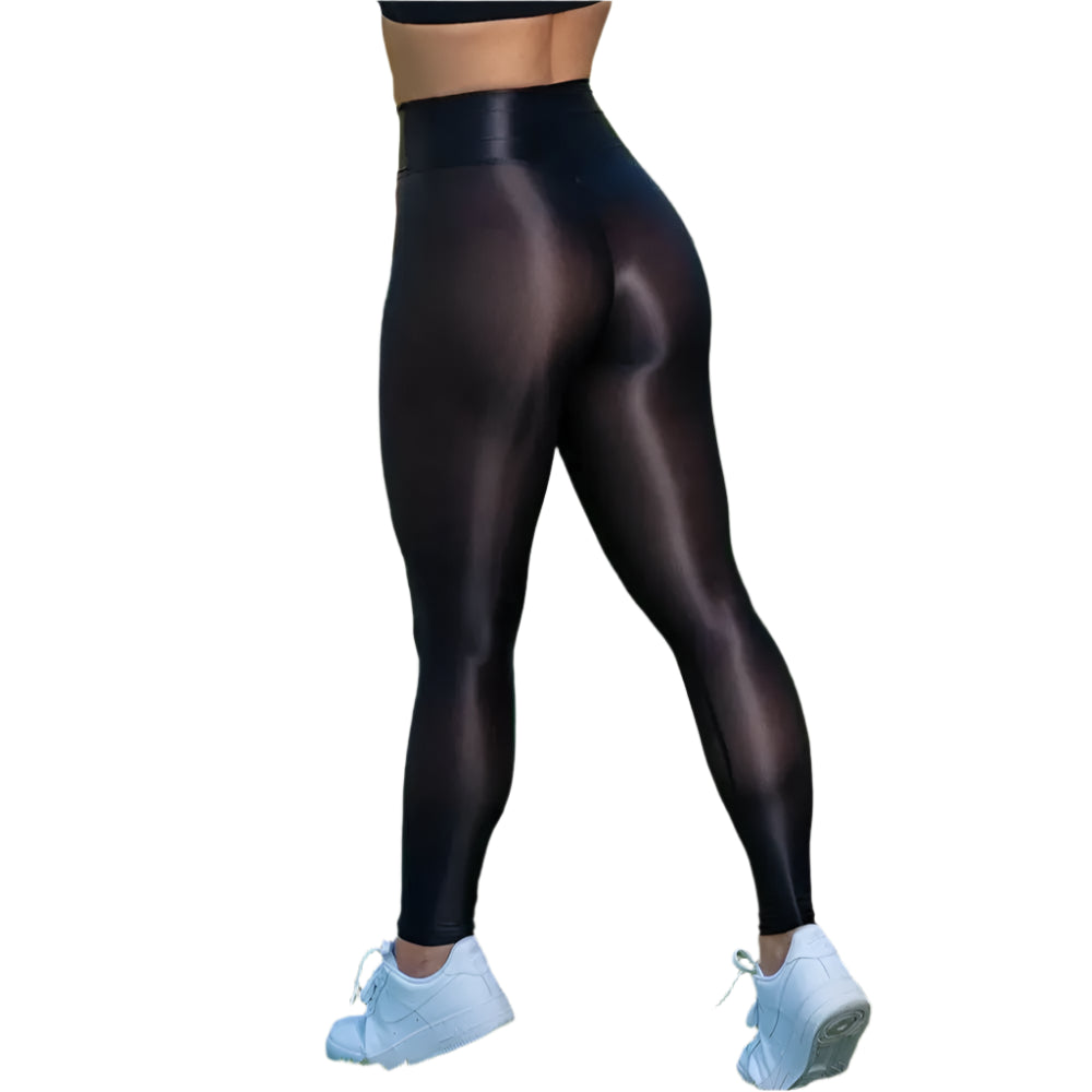 Person wearing black leggings and white sneakers on a grassy field