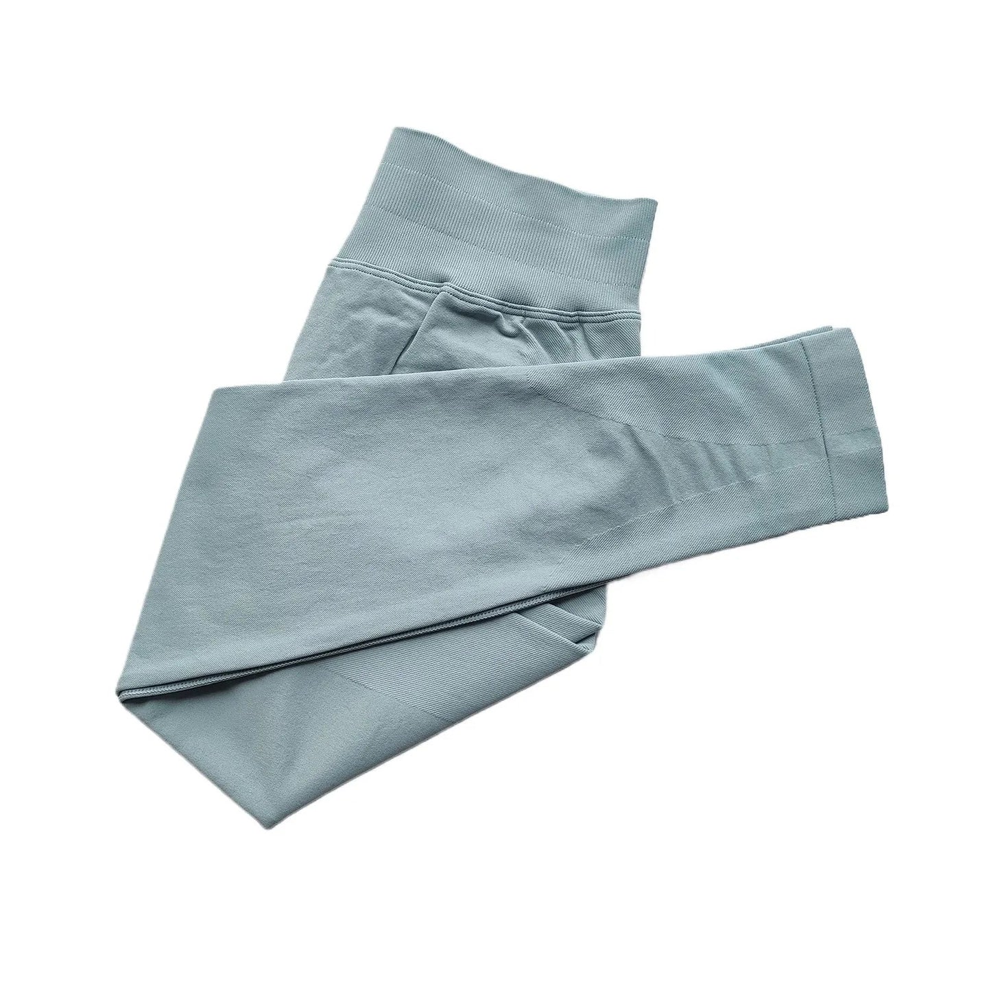 Folded light blue pants on a white background