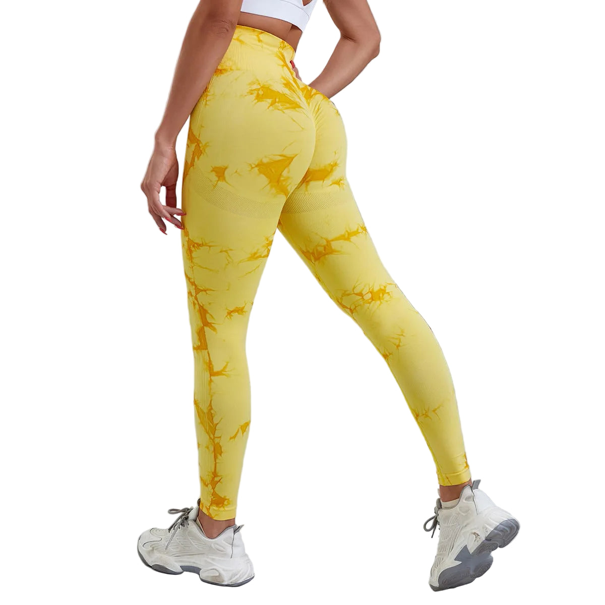 Three pairs of high-waisted workout leggings in tie-dye patterns, featuring colors blue, black, pink, and white. The leggings are designed to be seamless and are displayed on models wearing white sneakers.