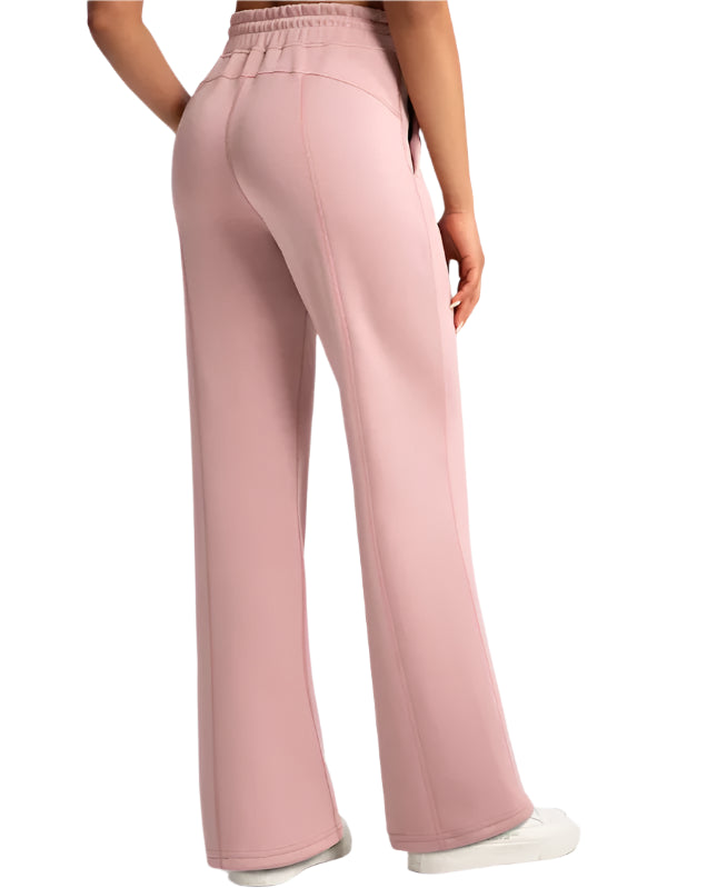 Pink wide-leg pants worn by a person on a white background