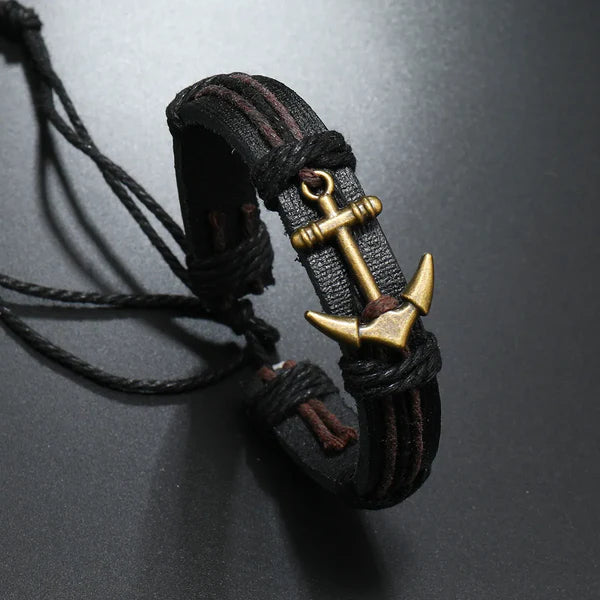 A black leather bracelet featuring a silver anchor charm, symbolizing strength and maritime adventure.