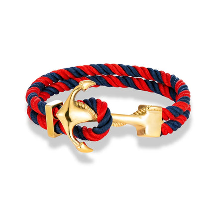  A red and blue rope bracelet featuring a silver anchor charm, symbolizing strength and nautical themes.