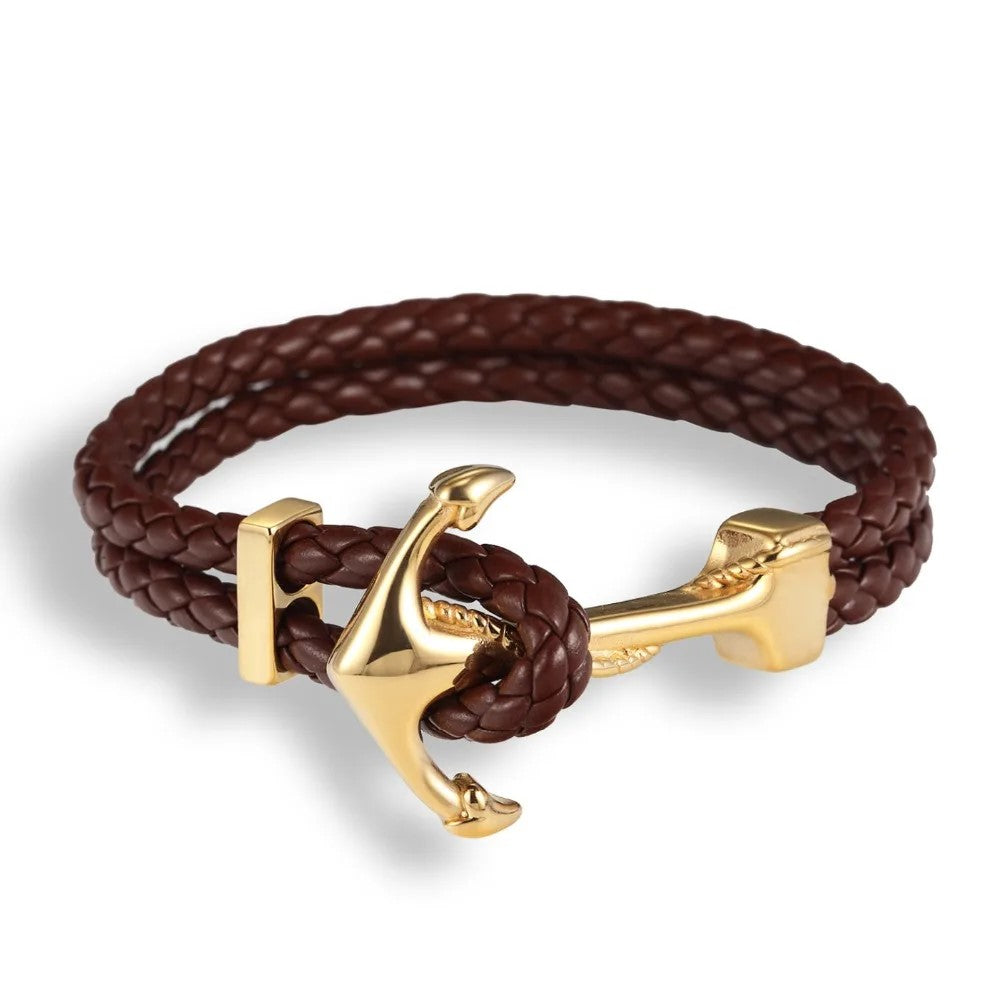  A stylish brown leather bracelet featuring a gold anchor charm, perfect for nautical-themed accessories.