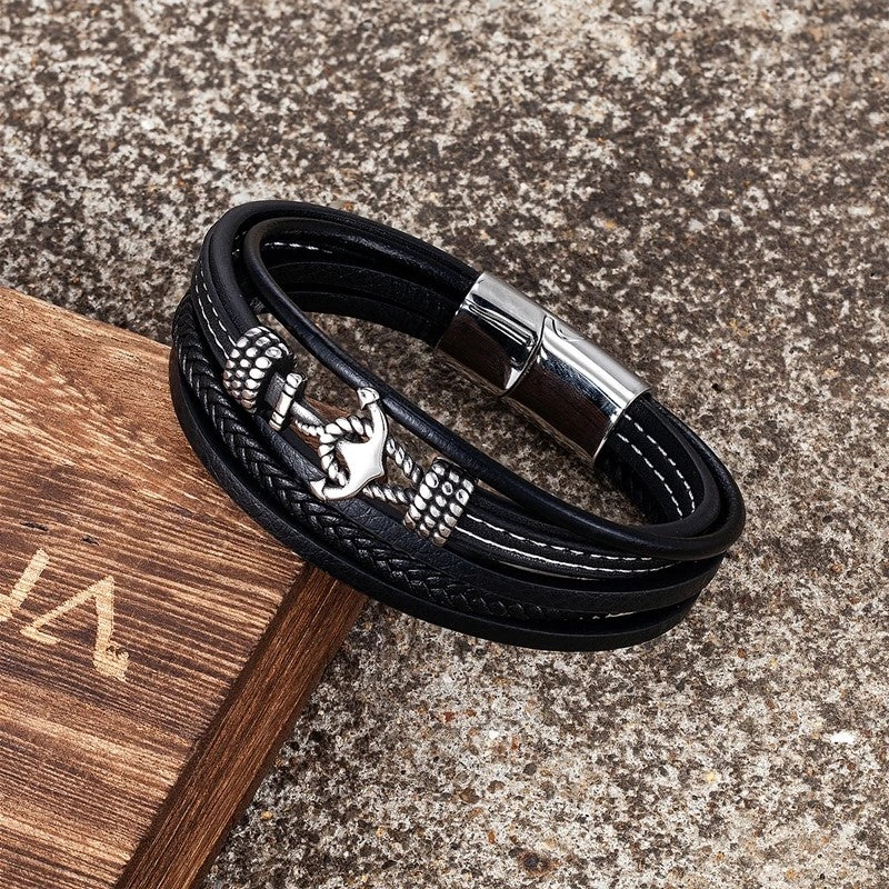 A fashionable black leather bracelet showcasing an anchor, ideal for adding a touch of nautical flair to any outfit.