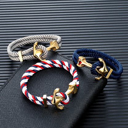 Three colorful rope bracelets featuring distinct anchor charms, showcasing a blend of style and nautical inspiration.