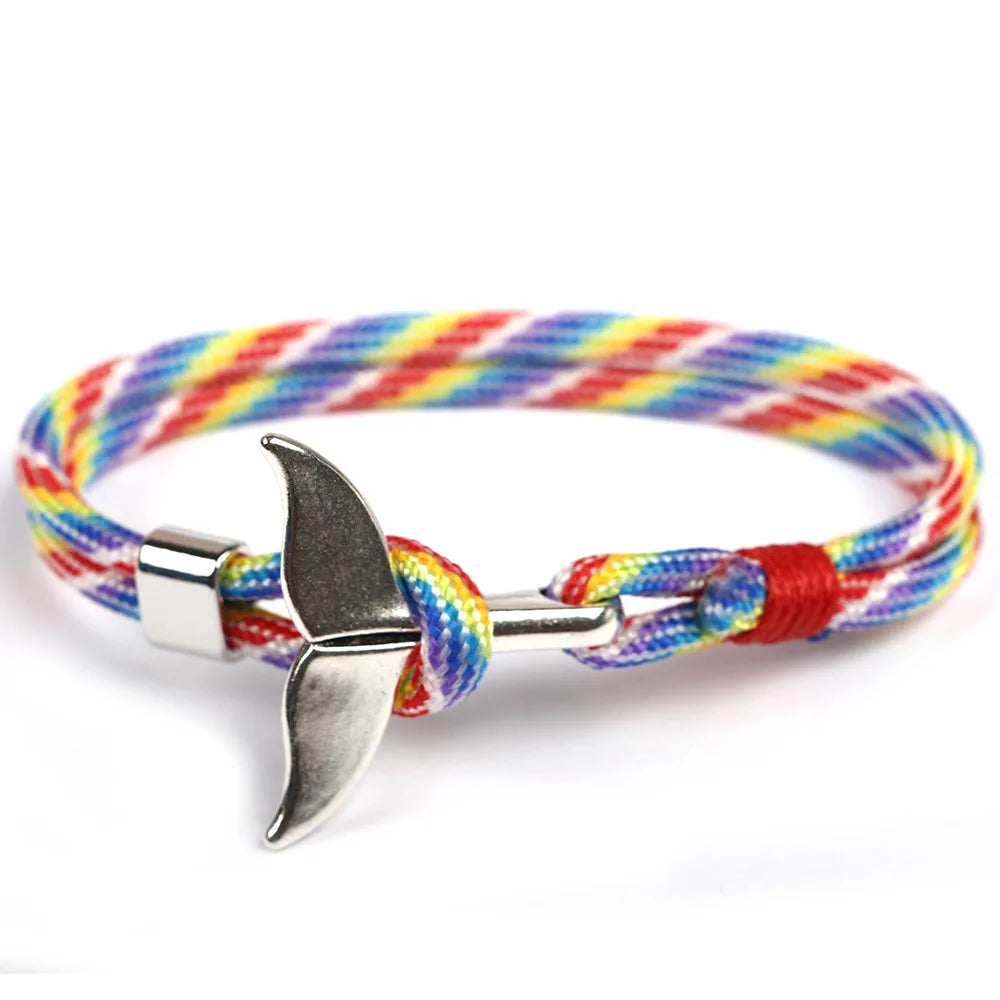 A vibrant rainbow rope bracelet featuring a sleek silver anchor charm, perfect for adding a splash of color to any outfit.