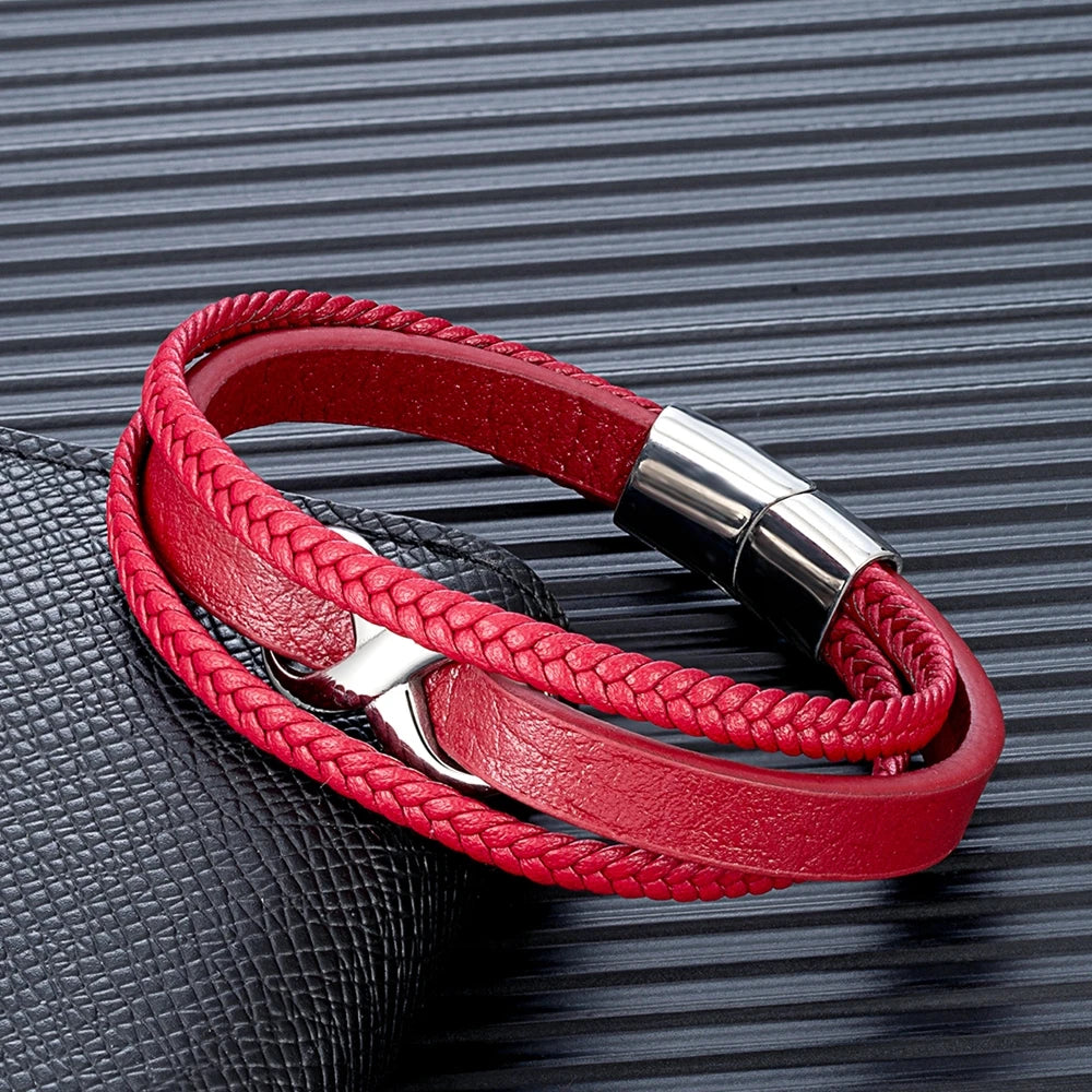 A red leather bracelet featuring a silver clasp and a stylish leather band, showcasing elegance and craftsmanship.