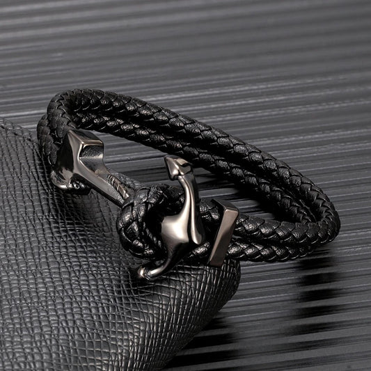 A stylish black leather bracelet featuring a sleek silver anchor charm, perfect for nautical-themed accessories.