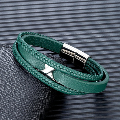 A green leather bracelet featuring a silver clasp and a stylish leather band, showcasing elegance and craftsmanship.