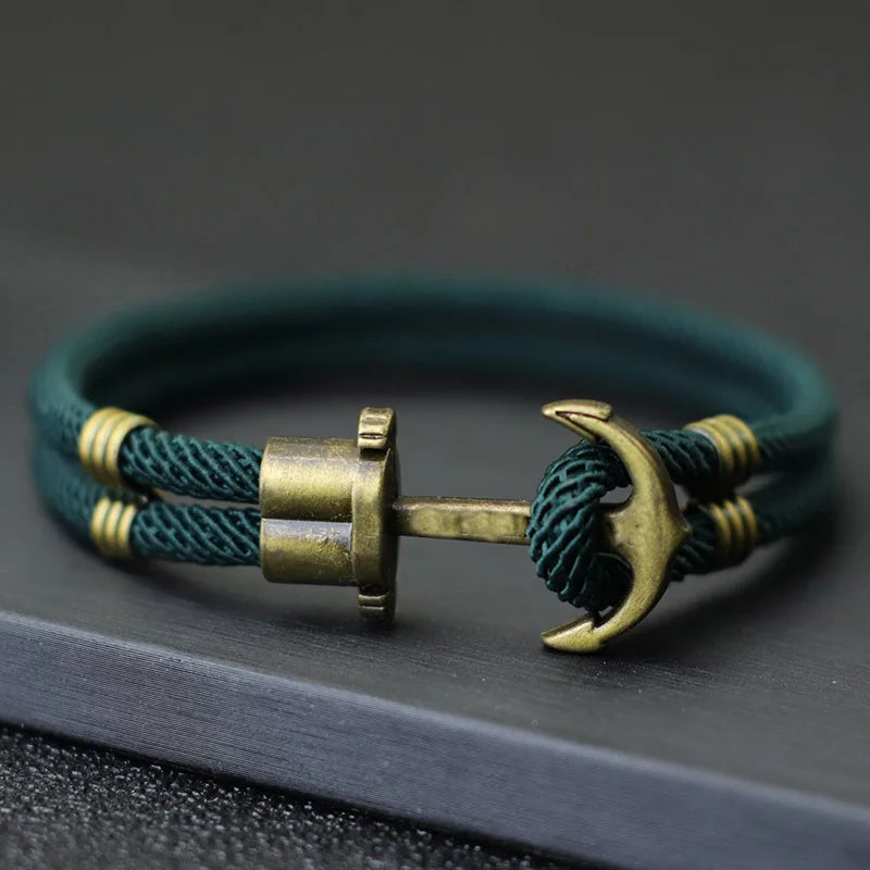 Anchor bracelet crafted from green cord and brass, showcasing a stylish and nautical-inspired design.
