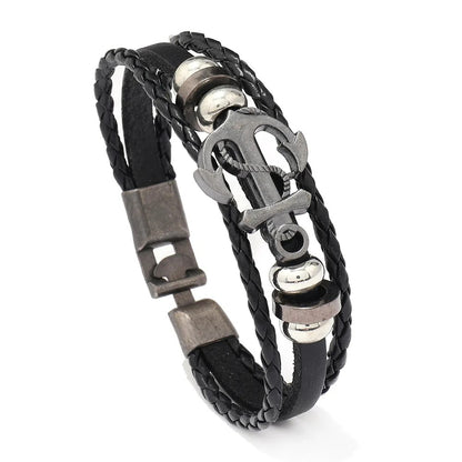  A trendy leather bracelet showcasing a metal anchor and a shiny silver clasp, blending elegance with a maritime vibe.