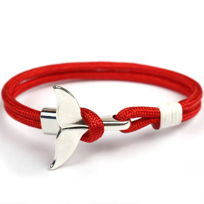 A stylish red rope bracelet featuring a sleek silver anchor charm, perfect for nautical-themed accessories.