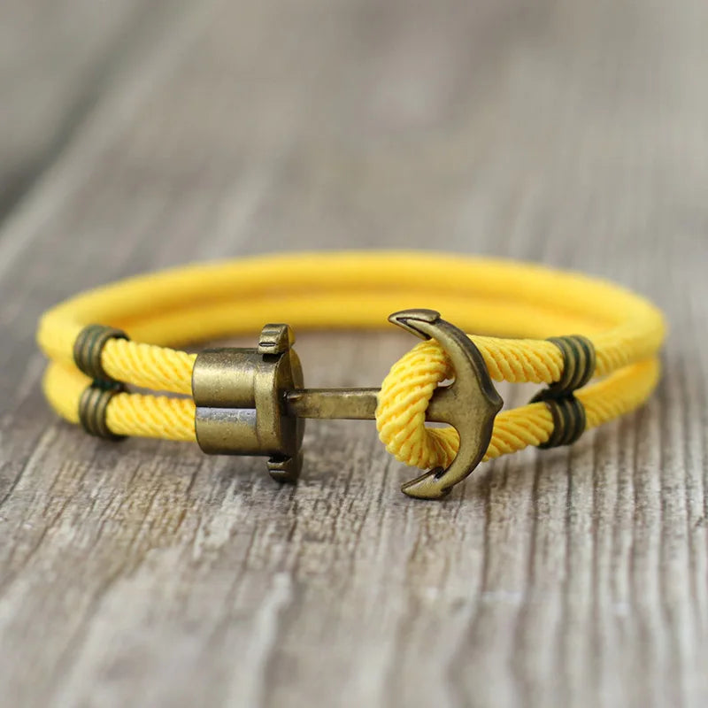 A vibrant yellow rope bracelet featuring a stylish anchor charm, perfect for nautical-themed accessories.