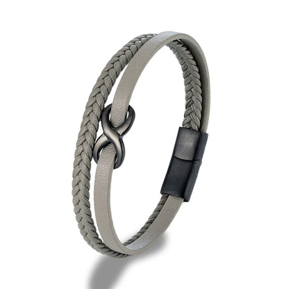  A gray leather bracelet featuring a black clasp, elegantly designed with an Infinity Knot motif on top