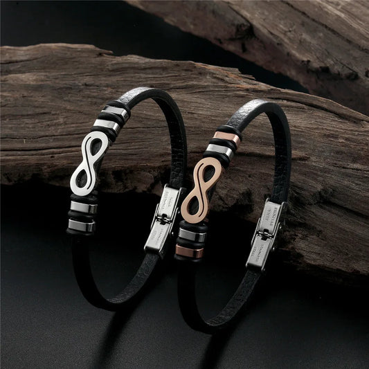 Two elegant black and gold bracelets featuring a stylish infinity symbol design, showcasing timeless beauty and sophistication.