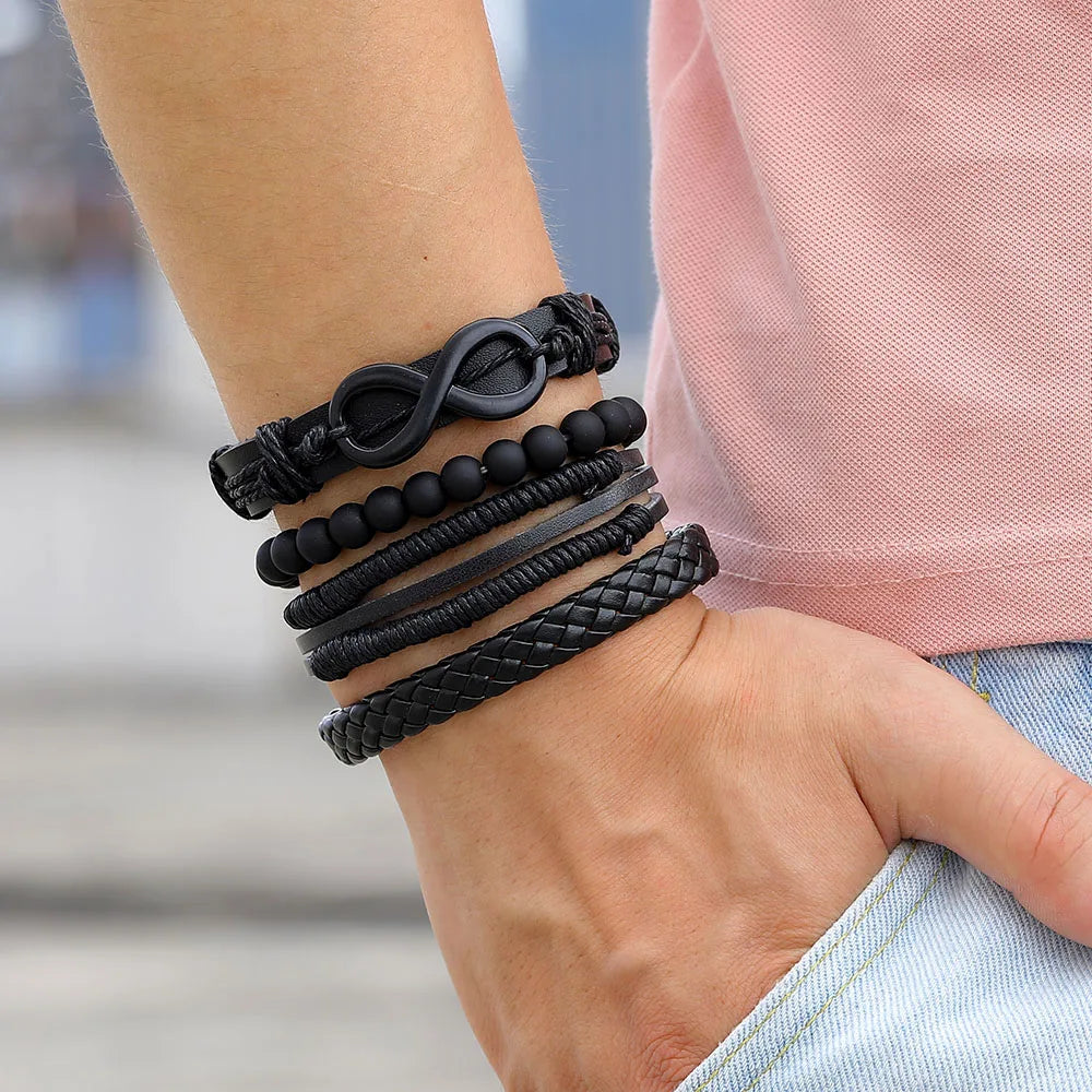 A close-up of a man's wrist adorned with a sleek black leather bracelet, emphasizing its modern and fashionable appeal