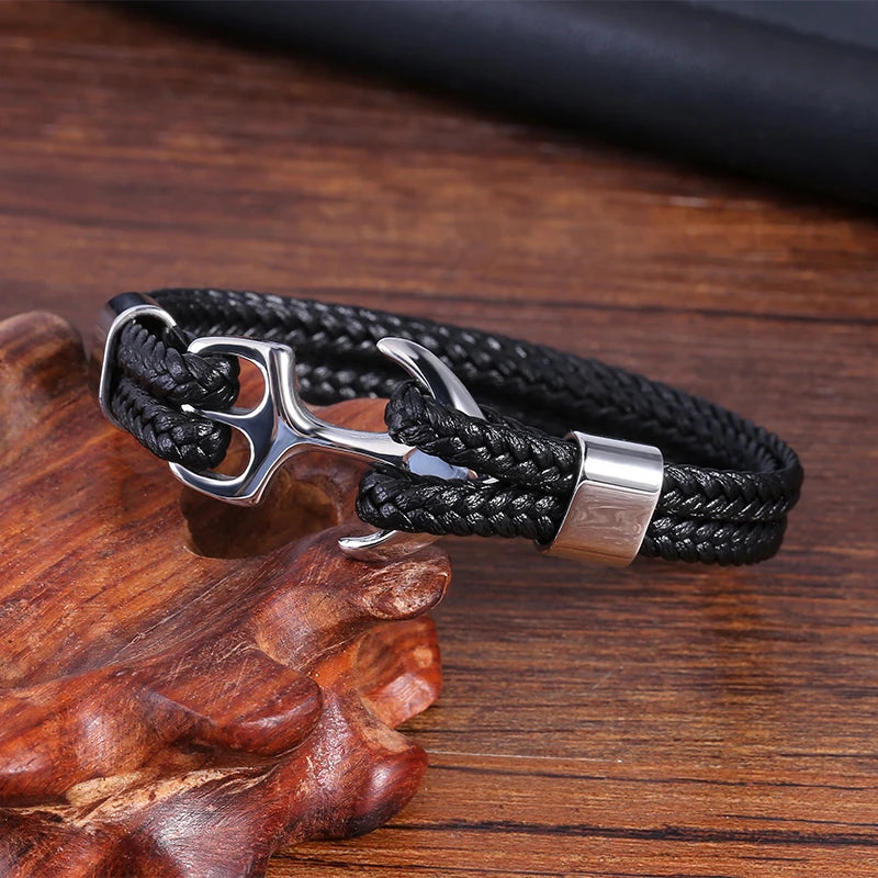 A stylish black leather bracelet featuring a sleek silver anchor charm, perfect for nautical-themed accessories.