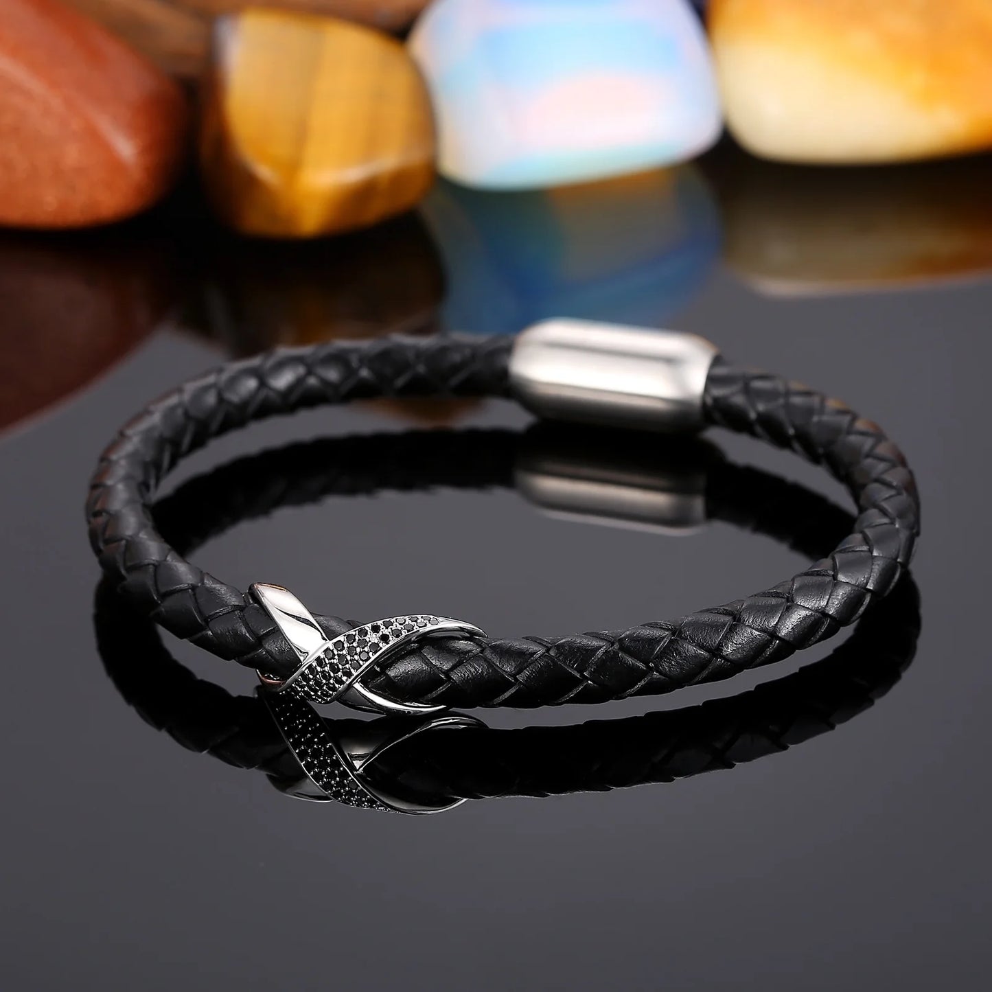 Stylish black leather bracelet with a silver clasp, showcasing an infinity knot for a unique and sophisticated appearance