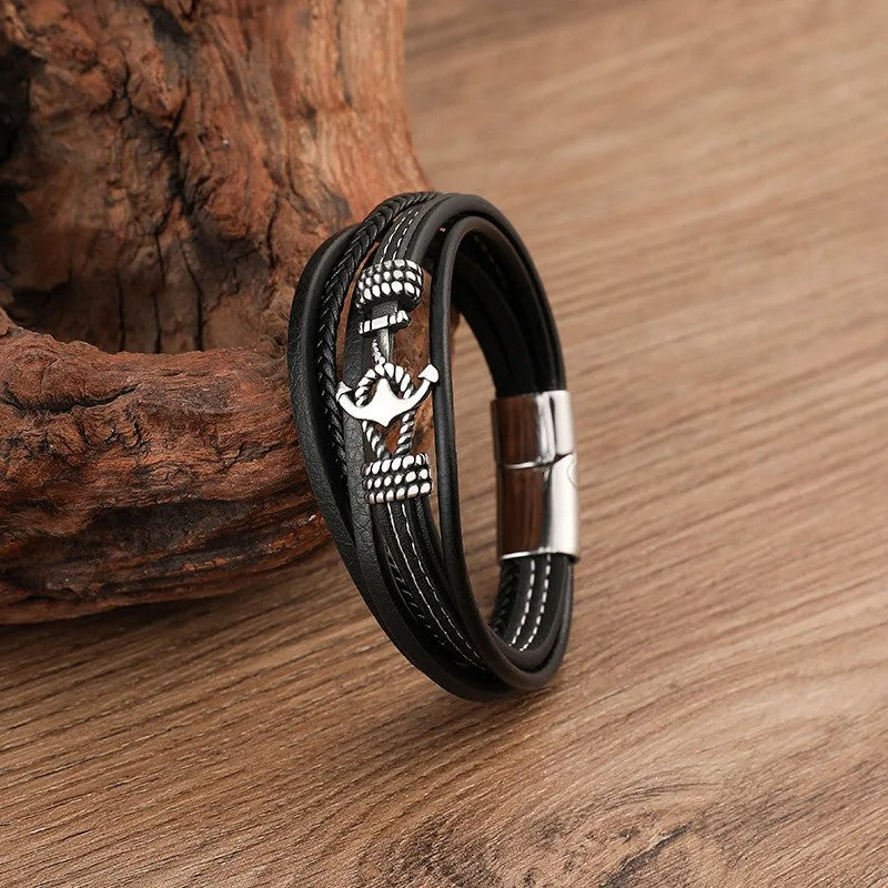A stylish black leather bracelet featuring a sleek silver anchor charm, perfect for nautical-themed accessories.