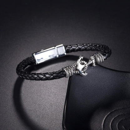 A stylish black leather bracelet featuring a sleek silver clasp, perfect for adding a touch of elegance to any outfit.