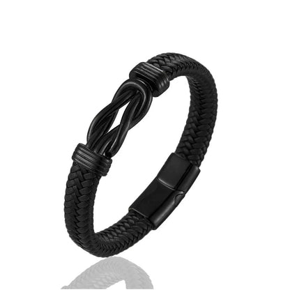 A stylish black braided leather bracelet with a matching black Infinity knot clasp, perfect for adding elegance to any outfit.