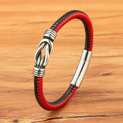 A vibrant red and black bracelet adorned with a polished silver clasp, showcasing a modern and fashionable design.