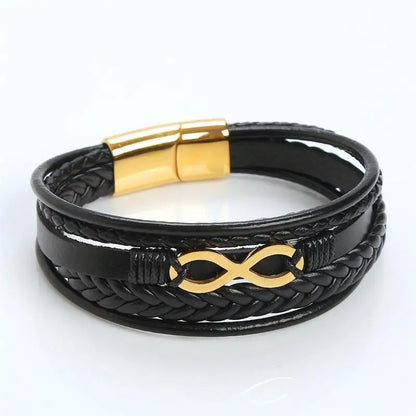  A black leather infinity bracelet featuring gold-plated brass accents, symbolizing eternal love and connection.