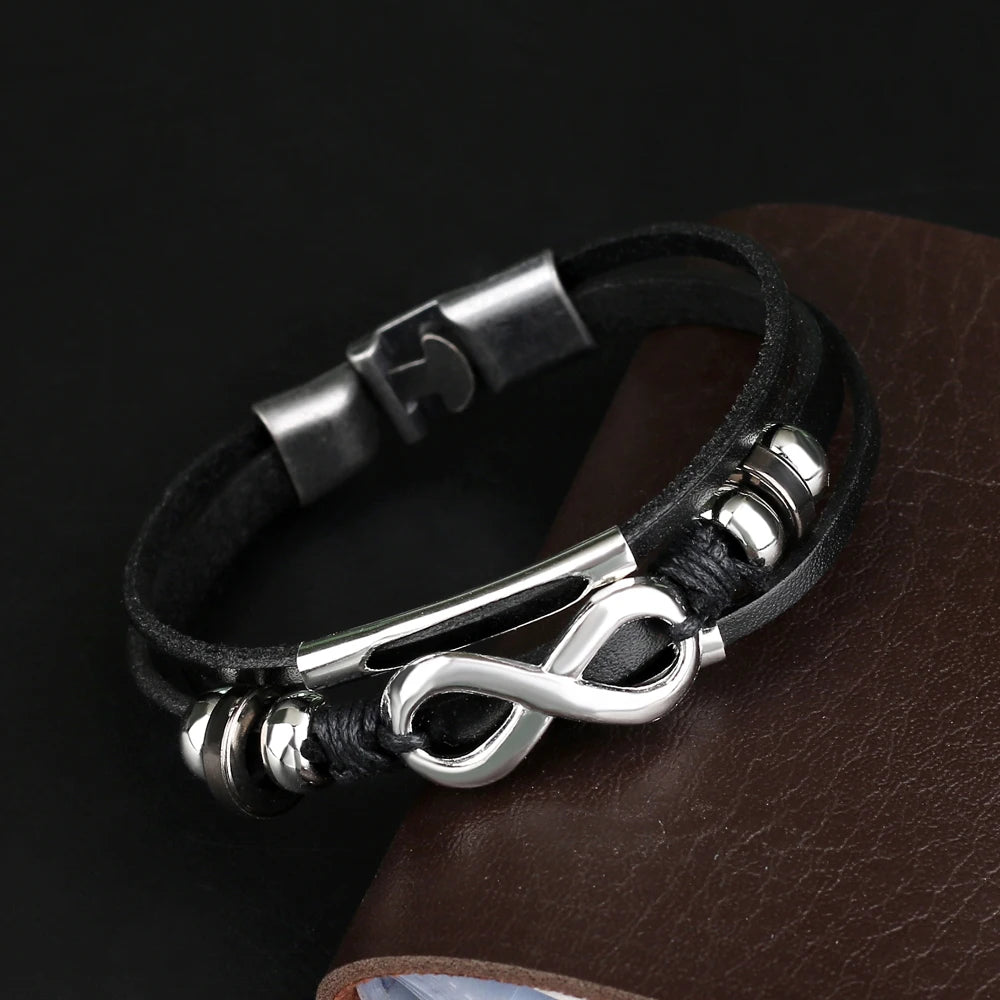 A black leather bracelet featuring a polished infinity symbol, symbolizing eternal love and connection.