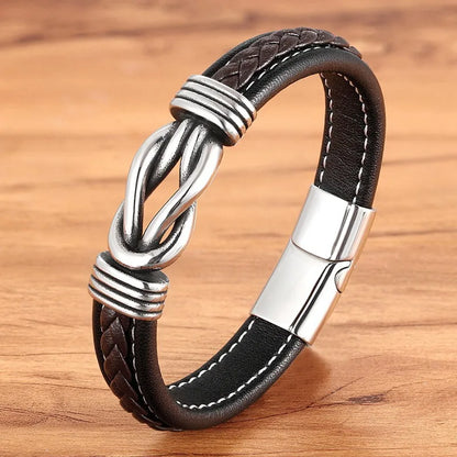 A black leather bracelet featuring a silver clasp, designed with an infinity knot motif for a stylish look.