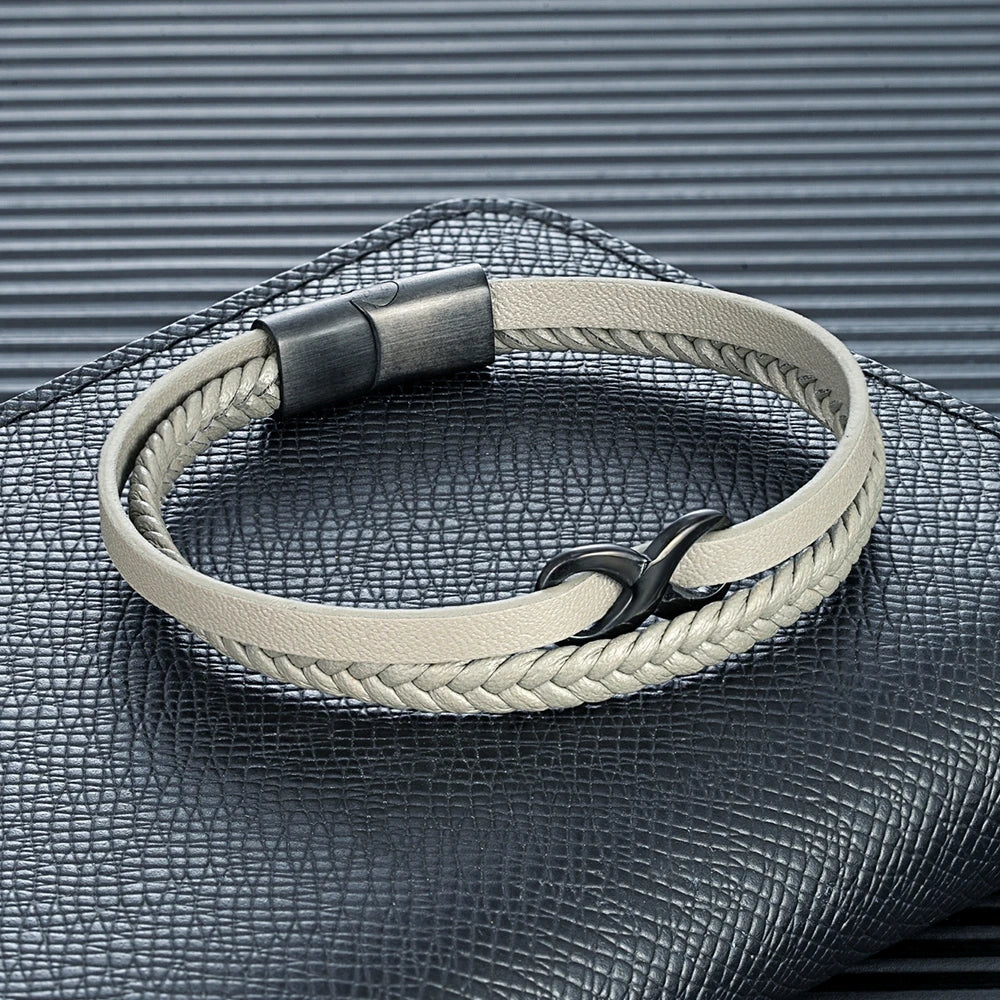 A stylish white leather bracelet adorned with a black clasp, showcasing an intricate Infinity Knot design on its surface