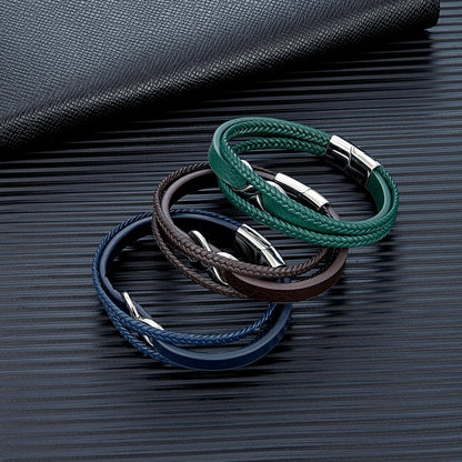 Three leather bracelets in varying colors displayed on a sleek black surface, showcasing their unique textures and styles.