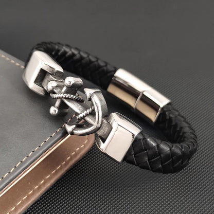 A sleek black leather bracelet adorned with a polished anchor, combining elegance with a maritime touch.