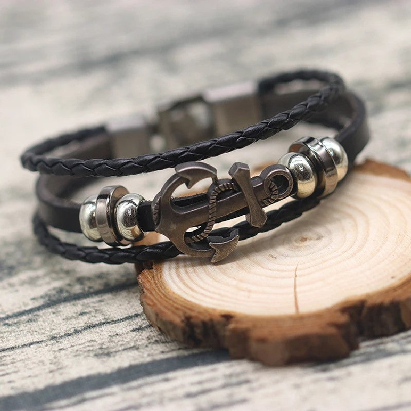 A trendy black leather bracelet showcasing an anchor and vibrant beads, perfect for a casual yet stylish look.