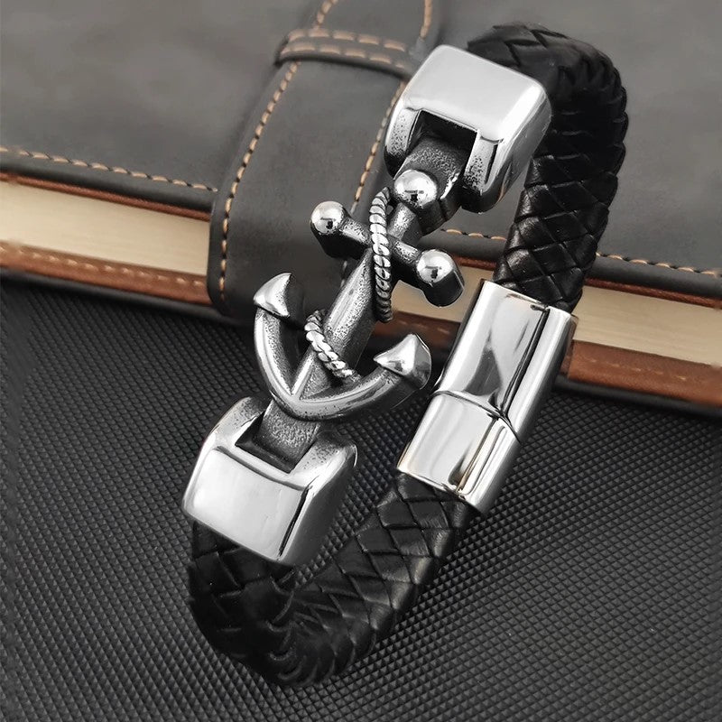 A stylish black leather bracelet featuring a silver anchor charm, perfect for nautical-themed accessories.