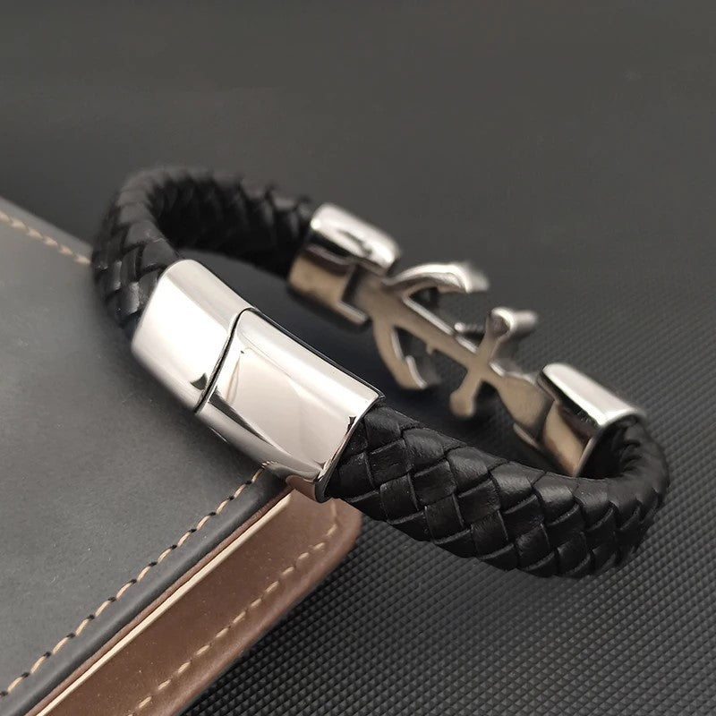 A stylish black leather bracelet featuring a sleek silver anchor charm, perfect for nautical-themed accessories.
