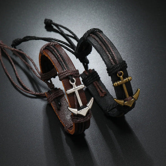 Two stylish leather bracelets featuring intricate anchor charms, showcasing a blend of elegance and nautical inspiration.