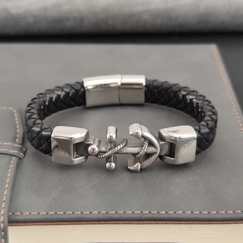 A trendy black leather bracelet showcasing a shiny silver anchor, ideal for adding a nautical flair to any outfit.