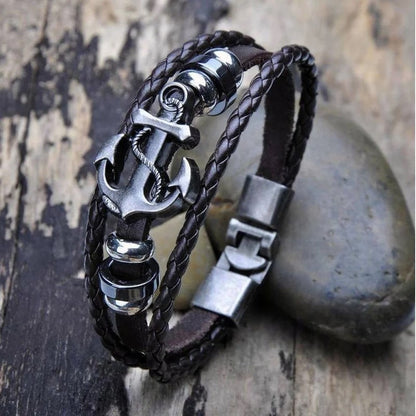 A chic leather bracelet adorned with an anchor design and a sturdy clasp, ideal for adding a maritime touch to any outfit.