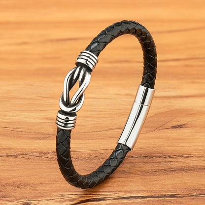 Stylish black leather bracelet with a polished silver clasp, ideal for both casual and formal occasions.