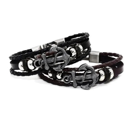 Two elegant leather bracelets showcasing an anchor and a durable metal clasp, combining style with a maritime flair.