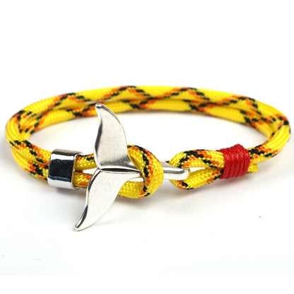 A vibrant yellow rope bracelet featuring a sleek silver anchor charm, perfect for nautical-themed accessories.