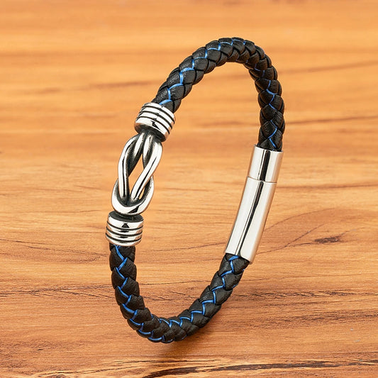 A black leather bracelet featuring a sleek silver clasp, showcasing a stylish and modern design.