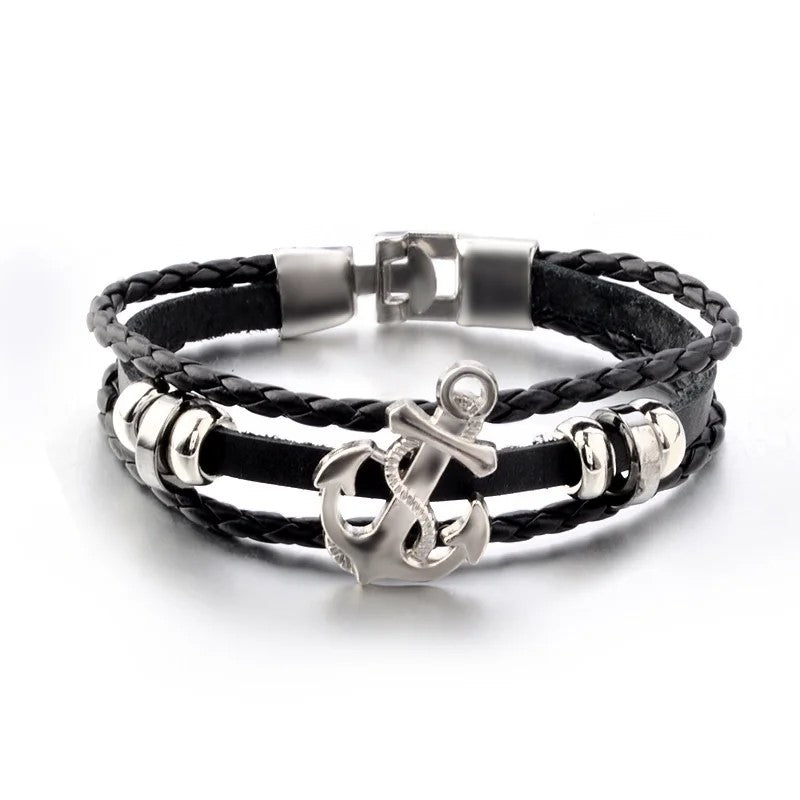 A stylish black leather anchor bracelet adorned with shimmering silver charms, perfect for adding a touch of elegance.