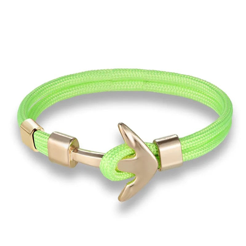  A vibrant green bracelet adorned with a charming anchor, ideal for adding a touch of maritime flair to any outfit.