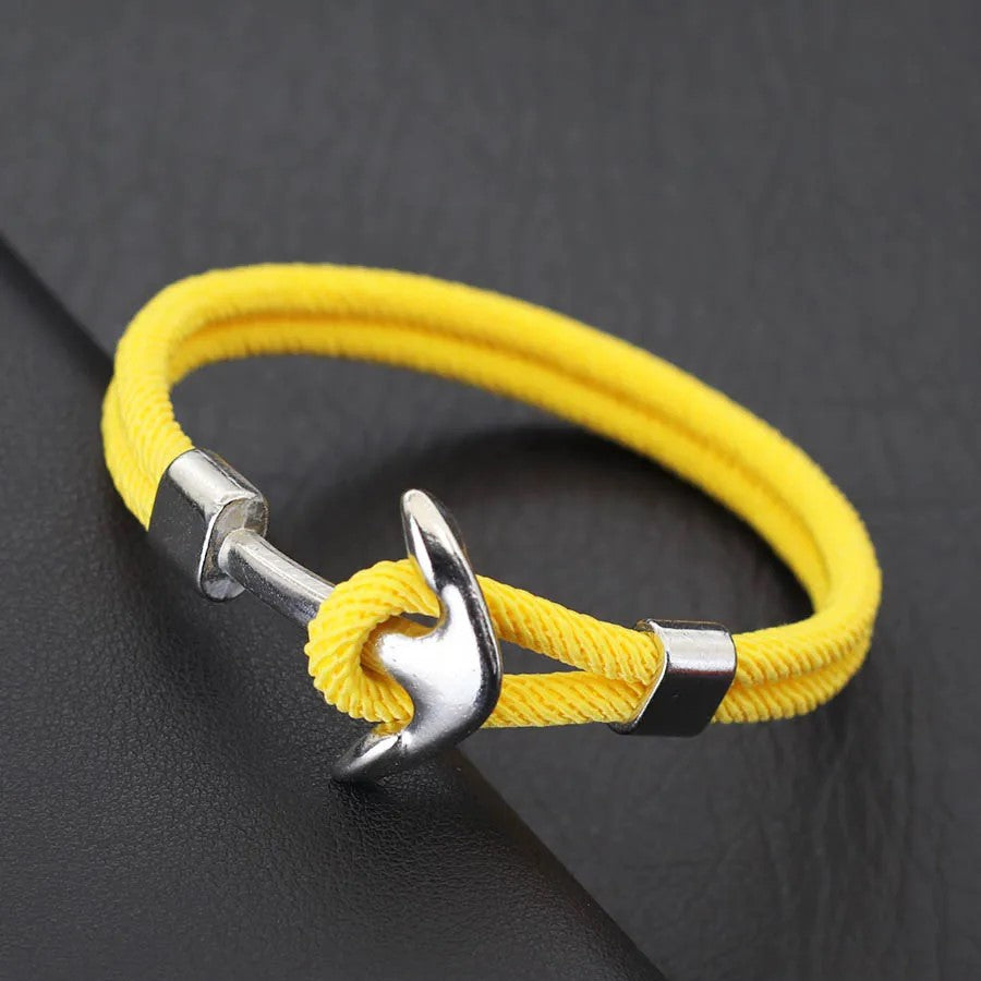 A cheerful yellow rope bracelet with a polished silver anchor, combining fun style with a nautical touch.