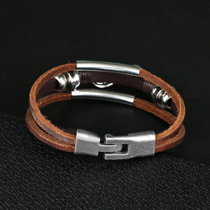 An infinity bracelet crafted from brown leather, adorned with two metal beads, representing eternal bonds and unity