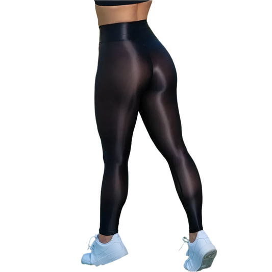 Person wearing black leggings and white sneakers on a grassy field