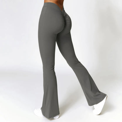 Gray flared pants worn by a person on a white background