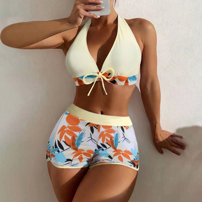 Woman wearing a colorful bikini with a plain background